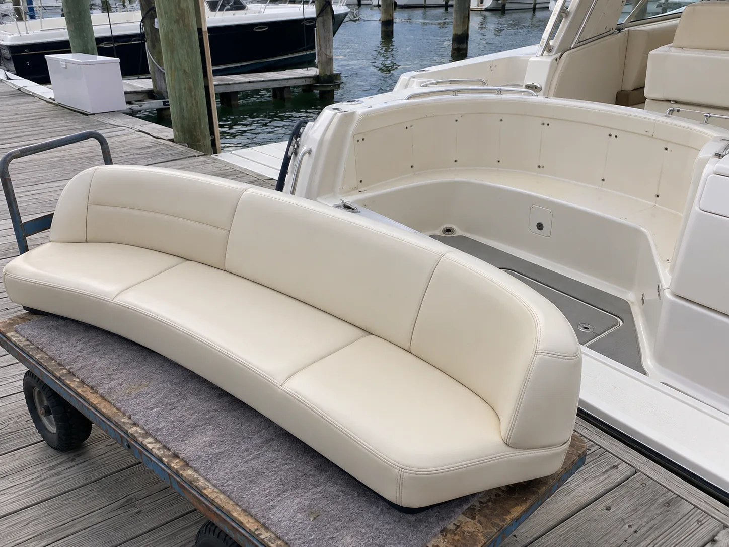 A boat bench cushion lifted off and set on a dock cart