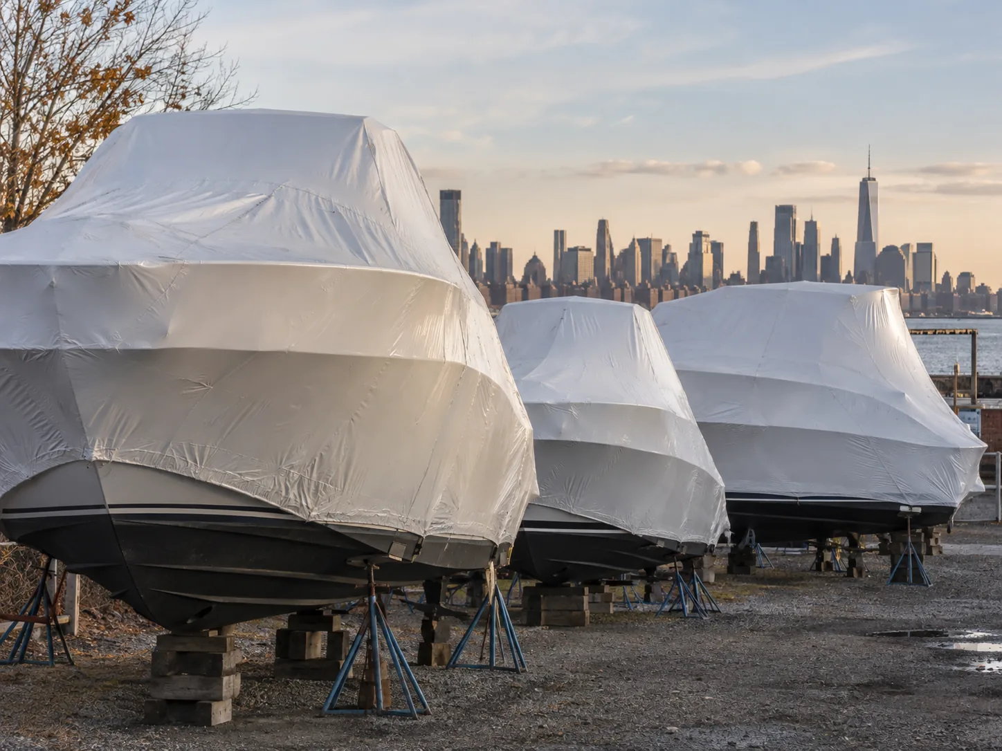 Boats on the hard in a yard, shrink-wrapped