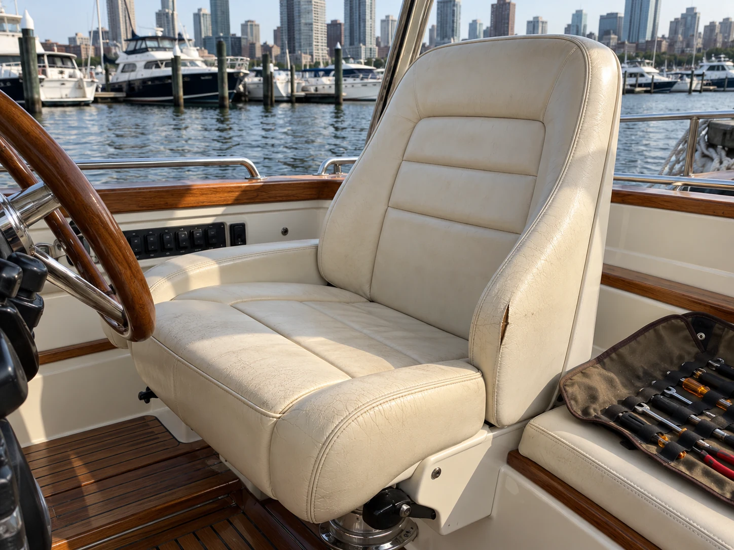 A split across the bolster of a cream boat helm seat