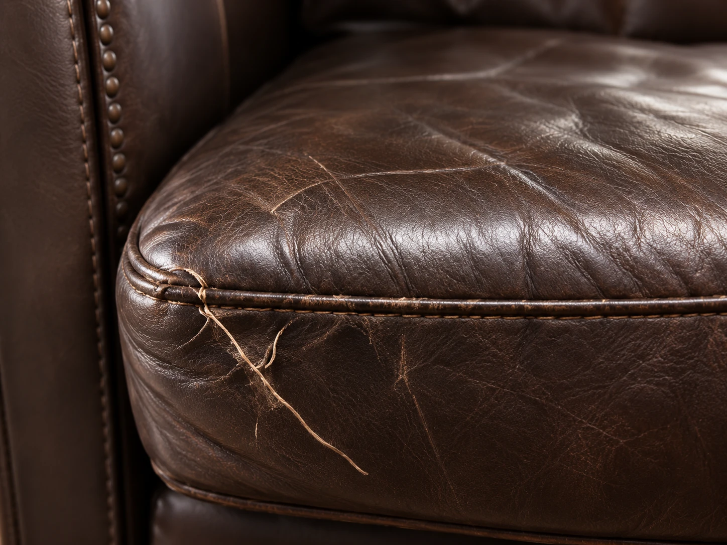 Surface scratches on a brown leather cushion