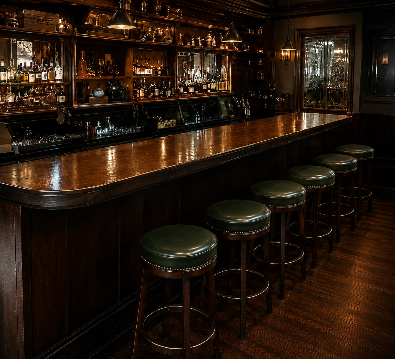 Five green leather round bar stools recovered along a dark wooden bar counter