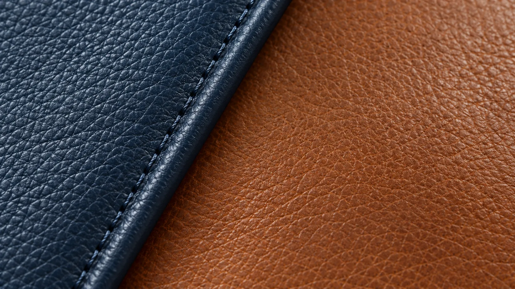 Close view of stitching along a navy and tan leather seam