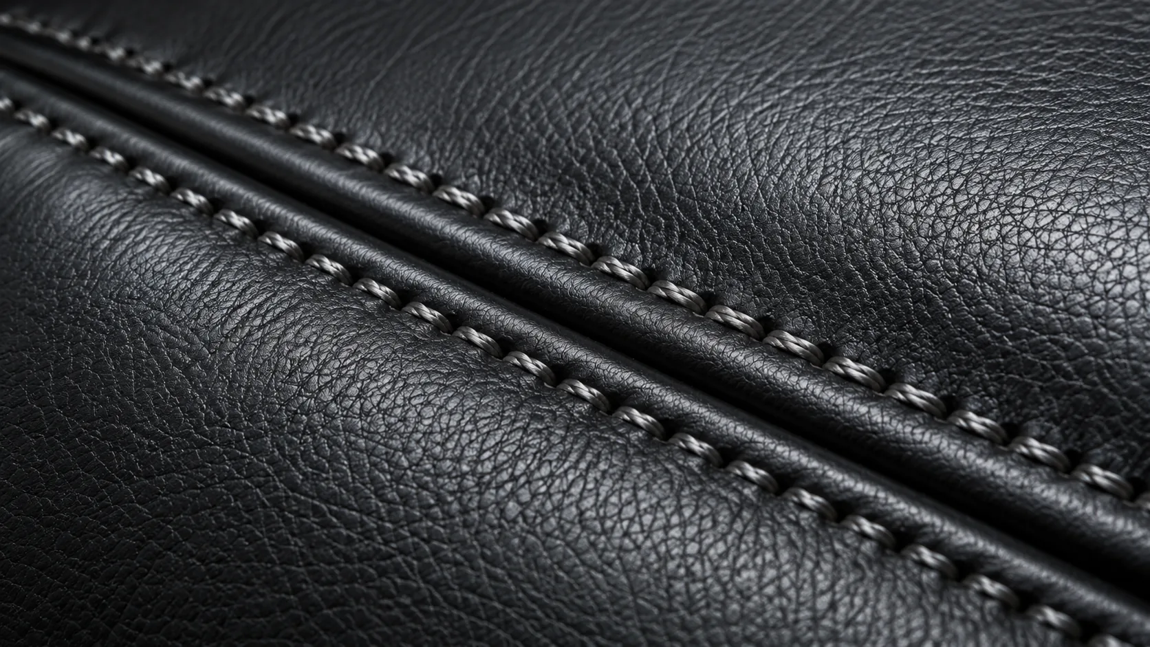 Stitched black leather showing its sheen