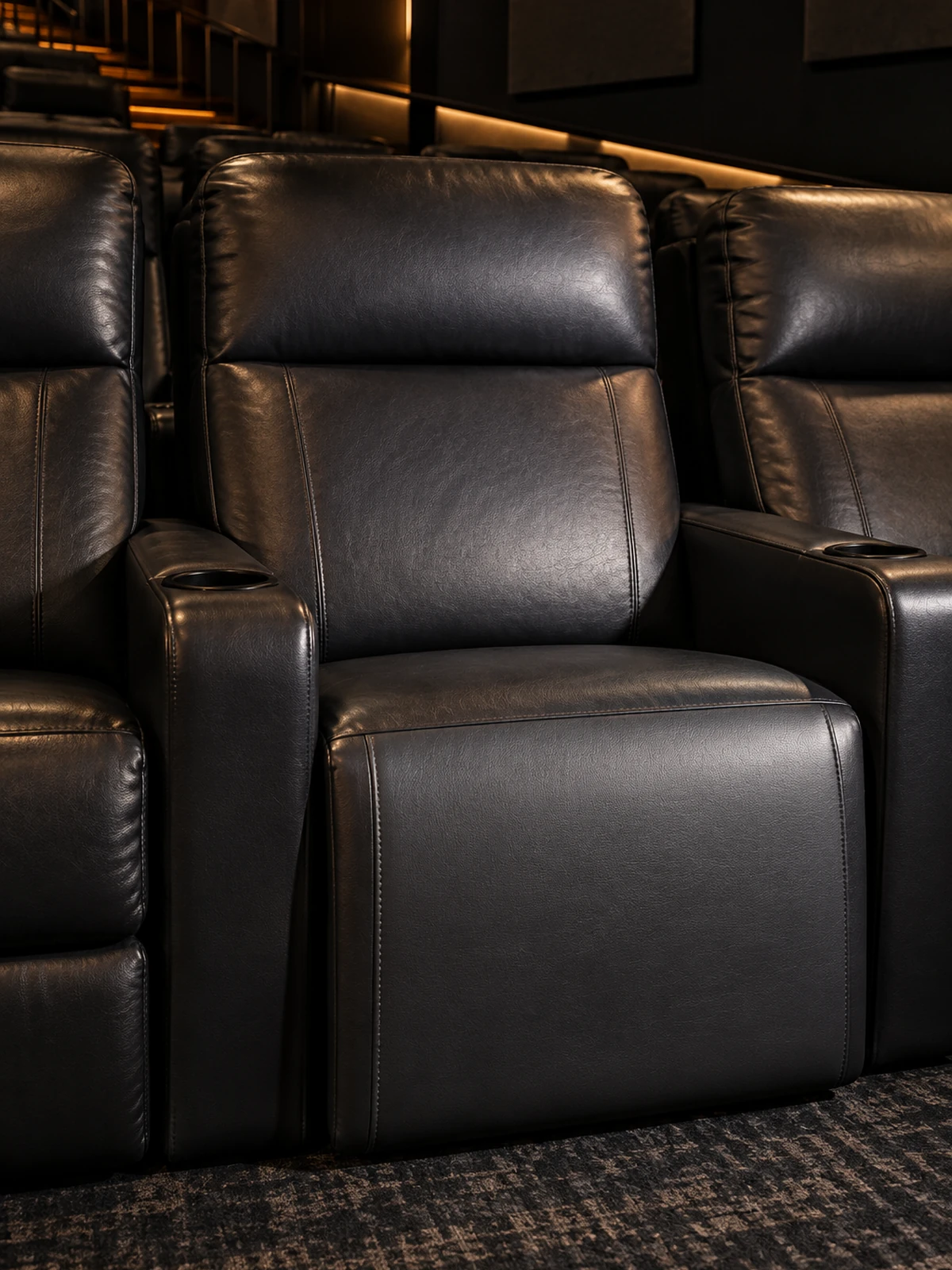 A refitted cinema seat panel, its color matched to the seats either side