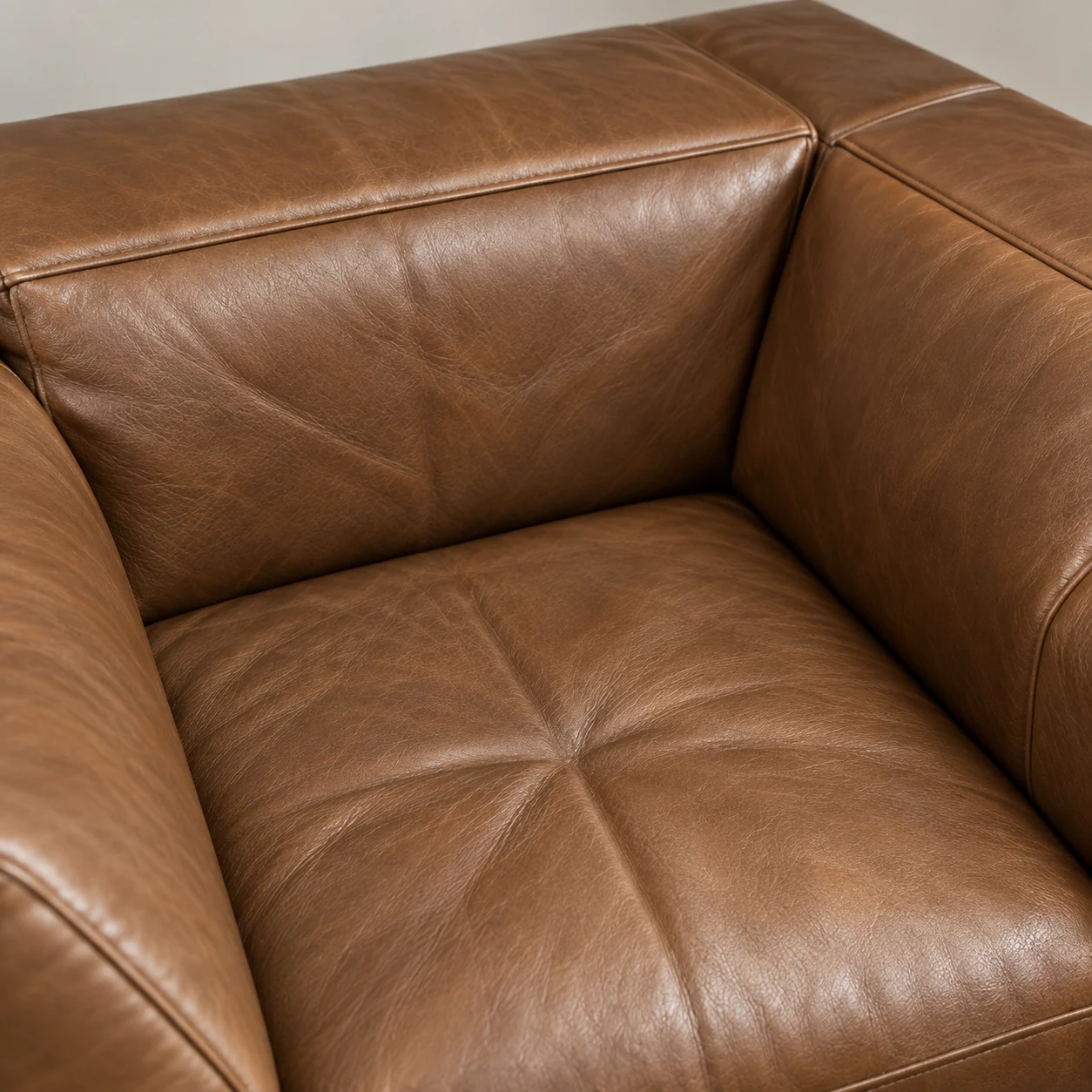 Corner seat cushion on a cognac leather sectional