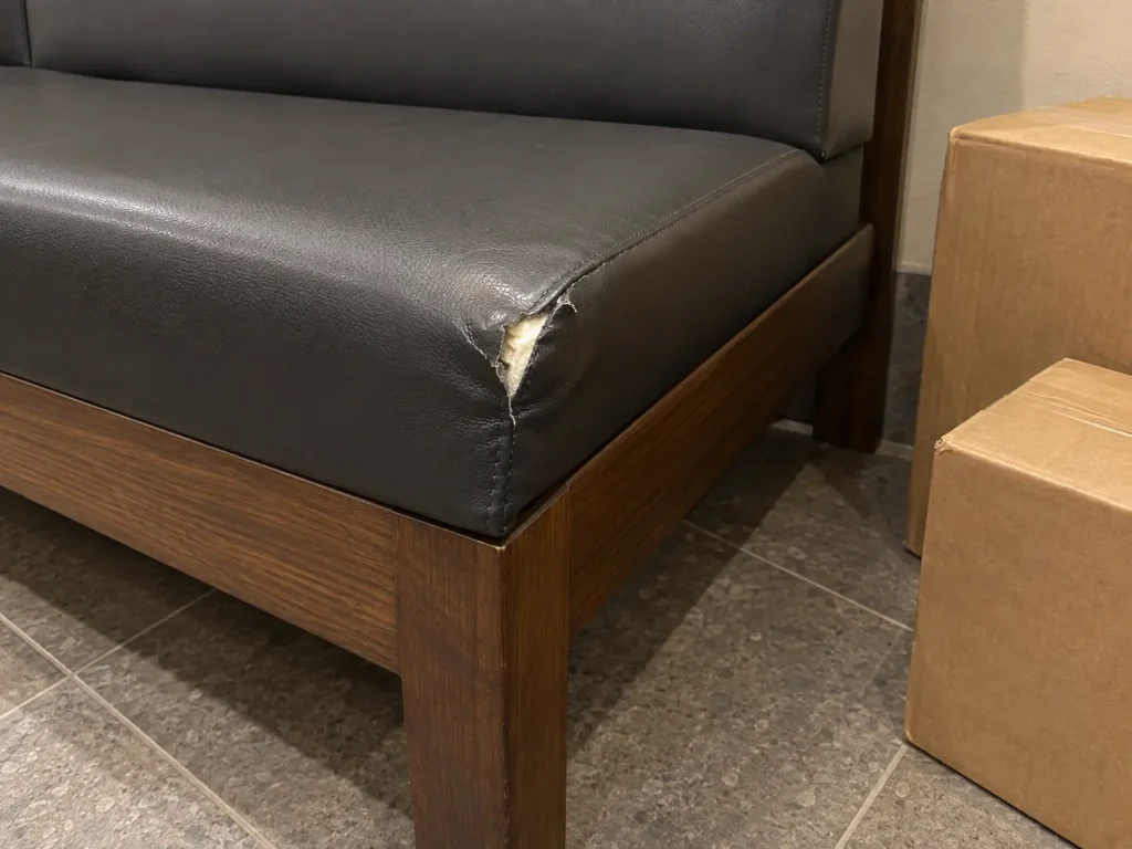 Bench corner torn by packages left in a mail area