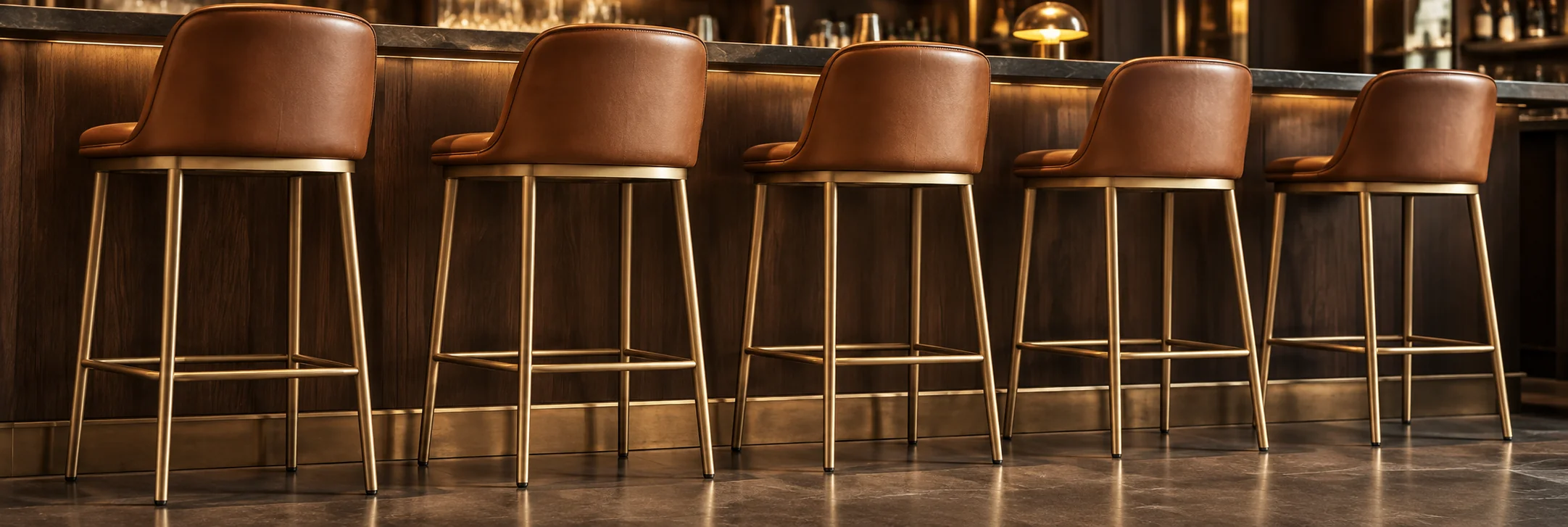 Tan leather bar stools along a bar counter