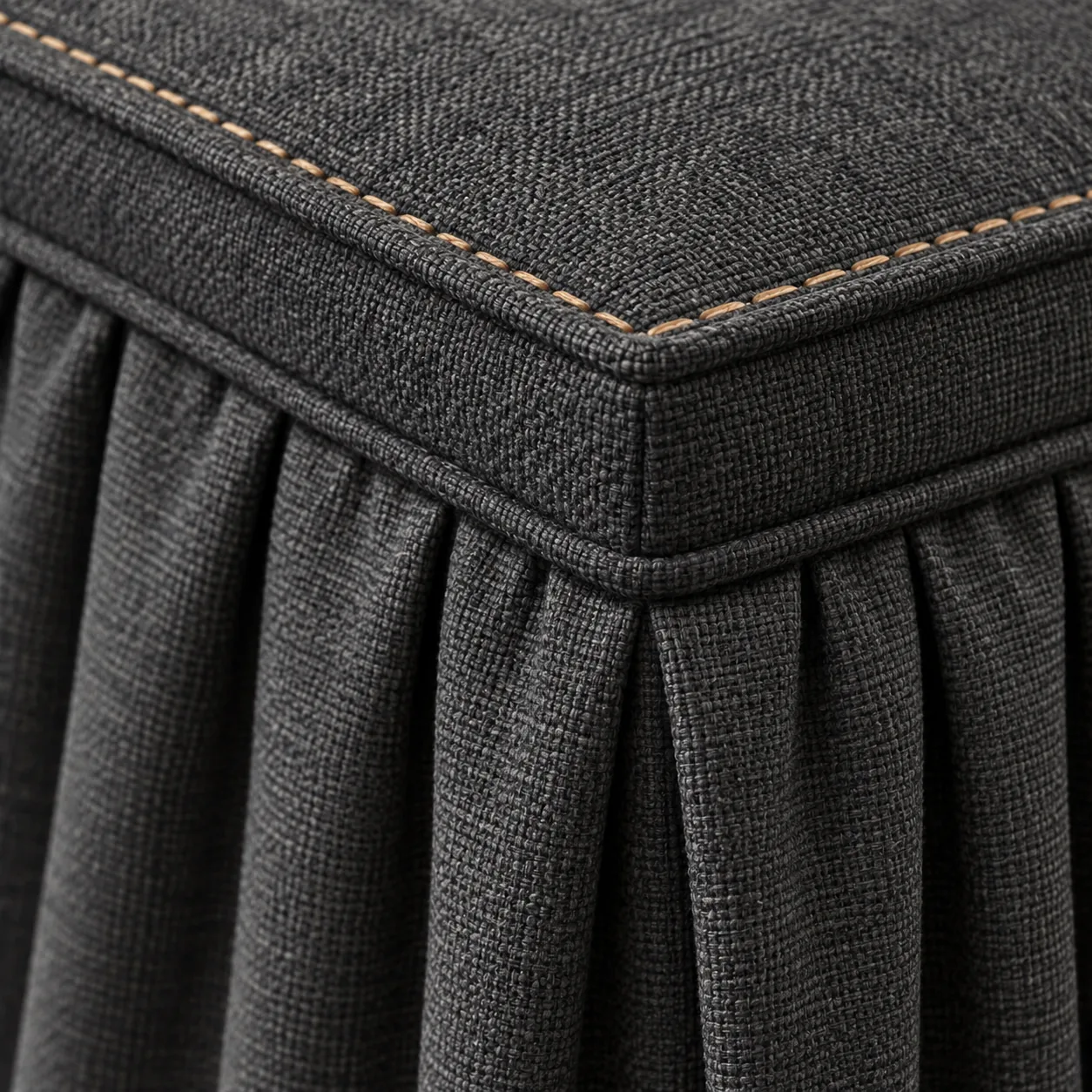Contrast saddle stitch worked over a welted top edge in charcoal cloth