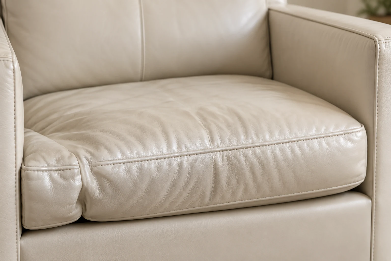 Flattened cream leather seat cushion that has lost its height