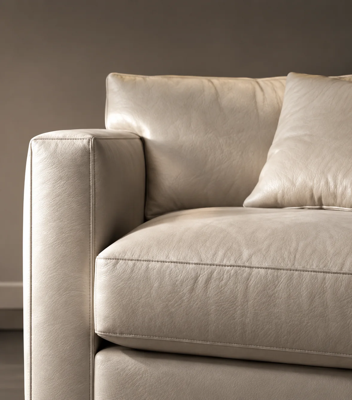 Cream leather sofa with a matching leather pillow