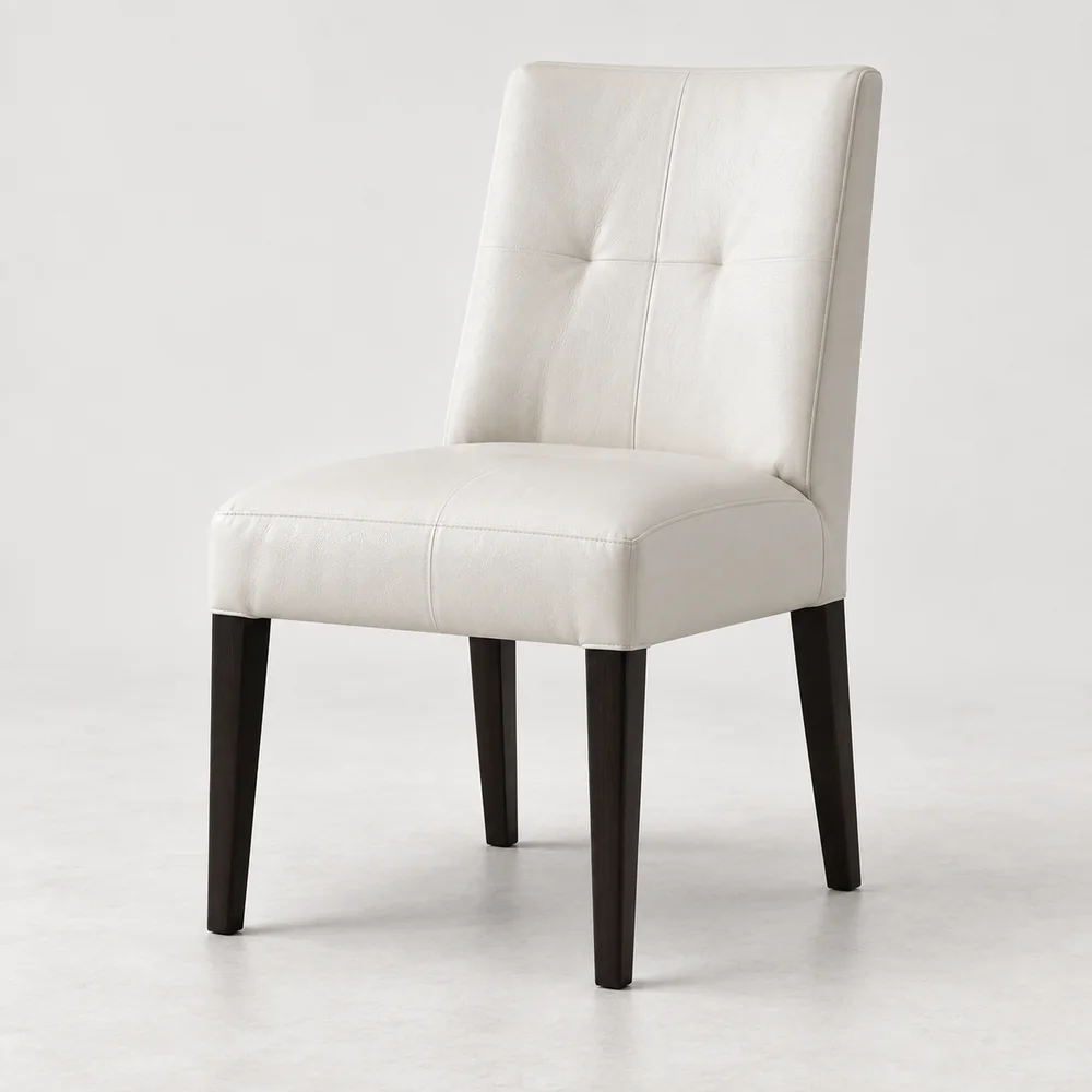 A cream leather dining chair with dark timber legs