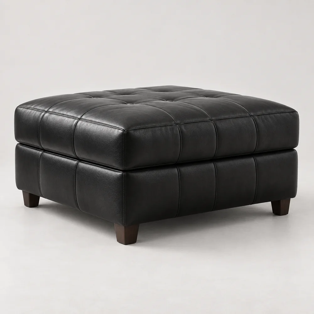 A tufted black leather ottoman