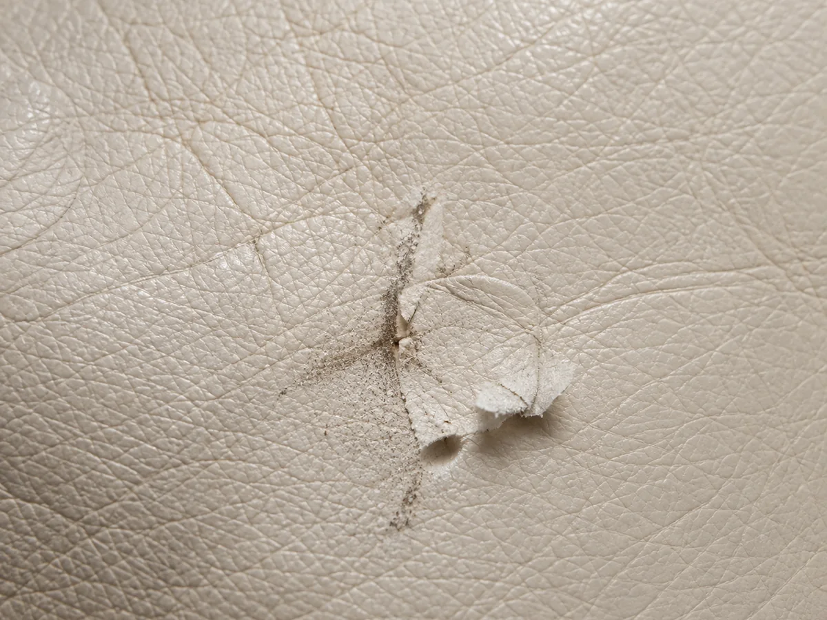 A scuffed patch where the leather finish has been rubbed back