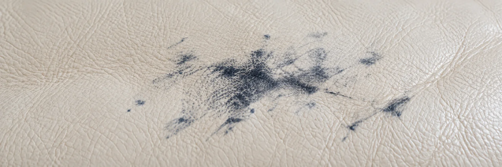 Blue dye transfer marking a pale leather seat