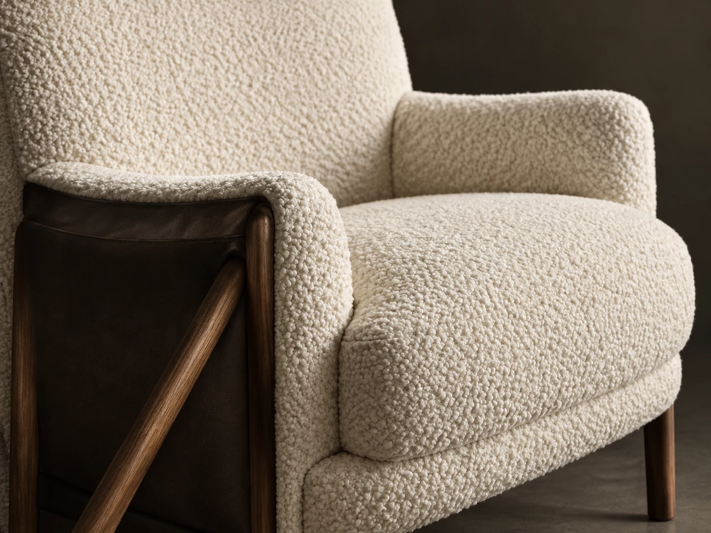 Lounge chair in cream boucle on an exposed walnut frame