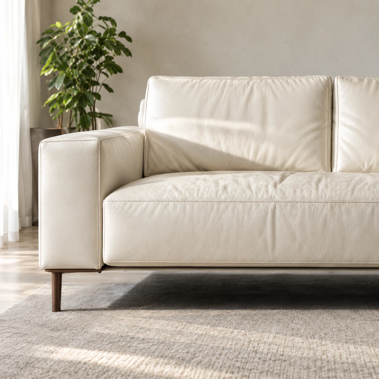 A cream leather sofa against a pale wall