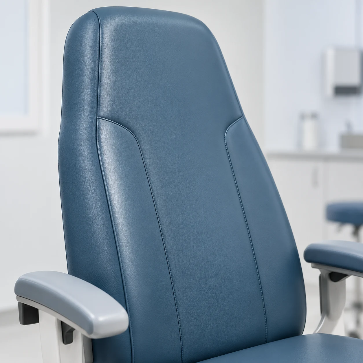 Close view of a recovered chair back and two fixed armrest caps in a clinic