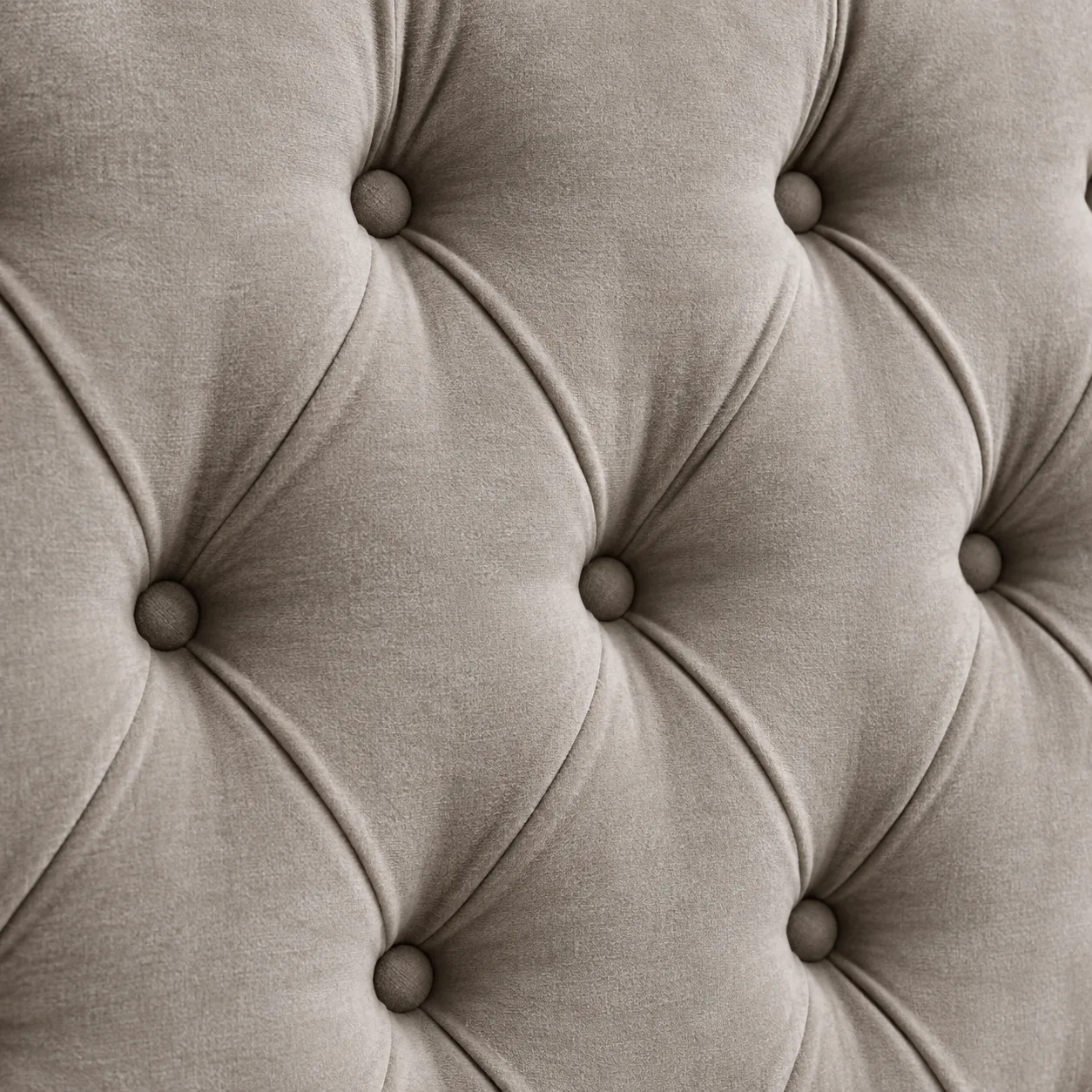 Diamond button tufting drawn into taupe velvet