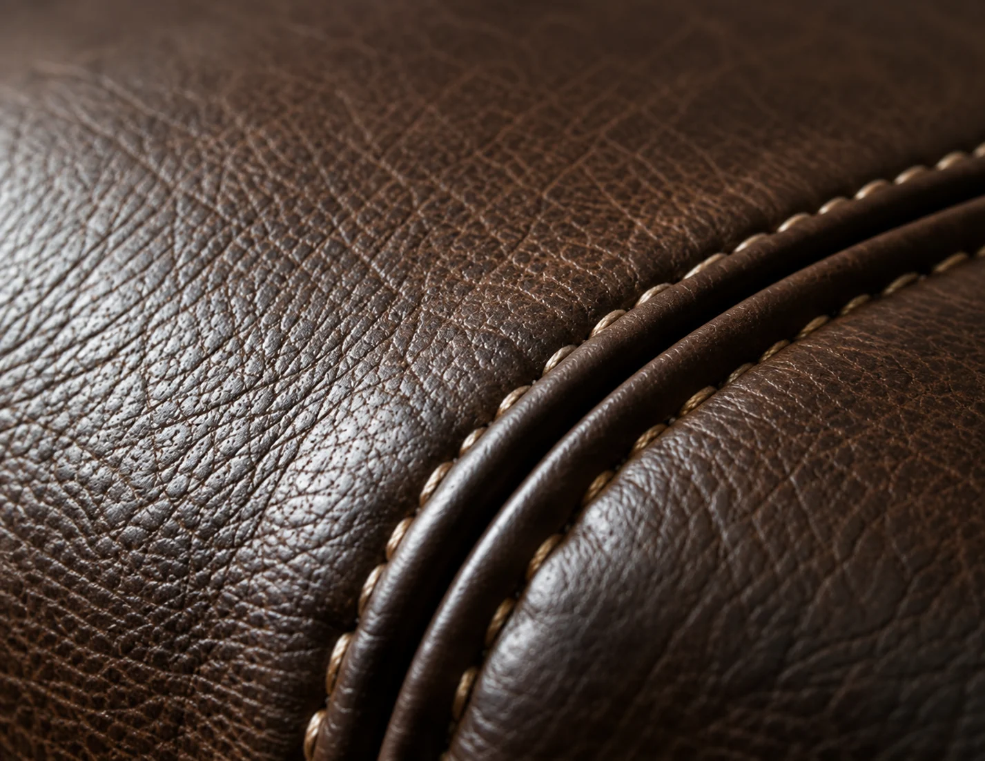 A double welt on dark brown leather with cream contrast stitching