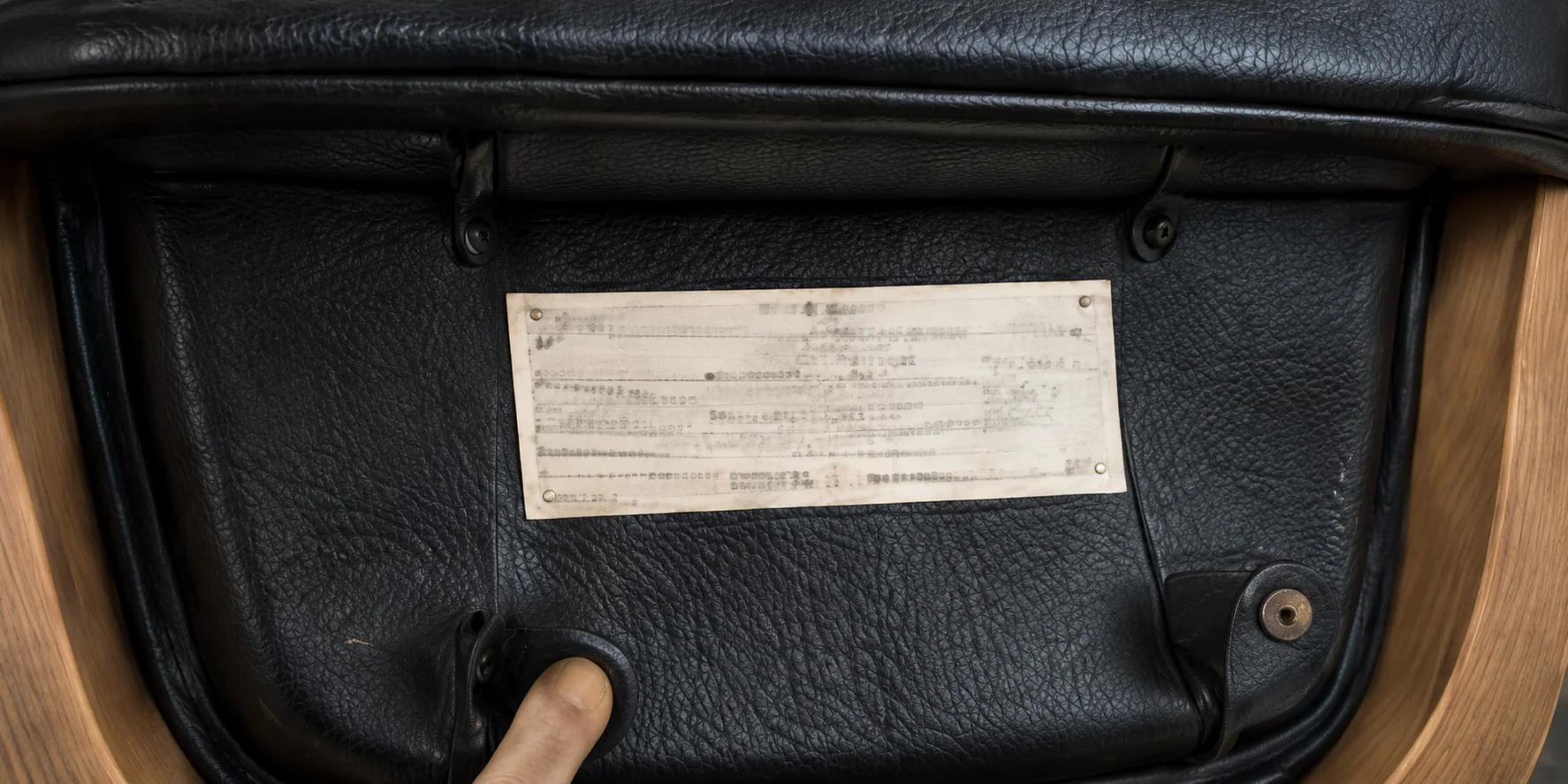 A label on the underside of an Eames lounge chair seat shell
