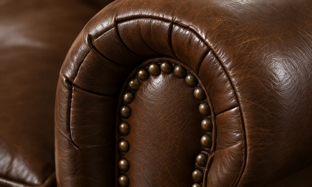 Rolled leather arm trimmed with nailheads
