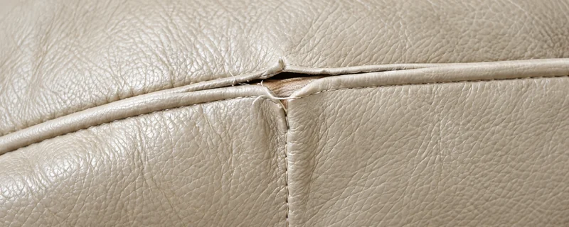 A split seam running along a leather cushion
