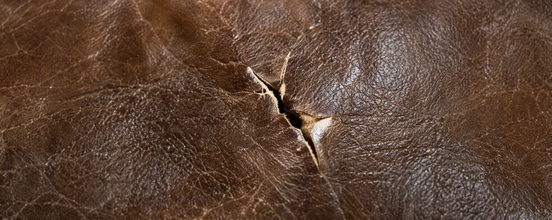 A small tear in a leather sofa panel