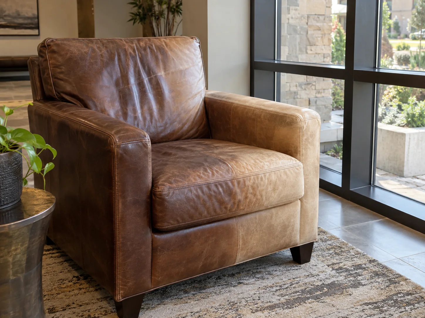 Faded leather lounge chair by a window