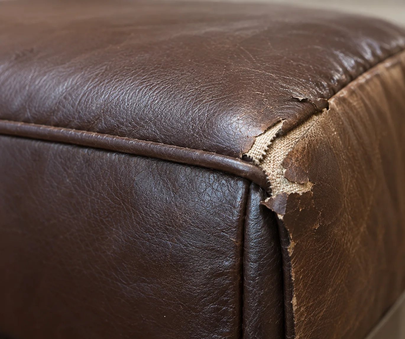 Brown bench edge where the topstitch has given way along the welt