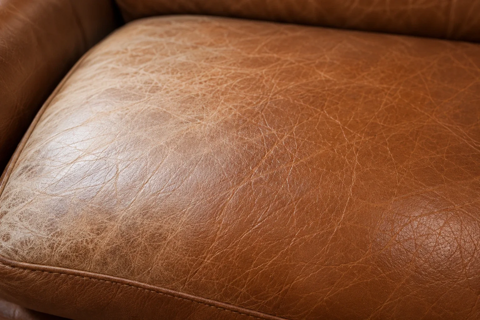 Leather showing a clear tone difference between exposed and protected areas