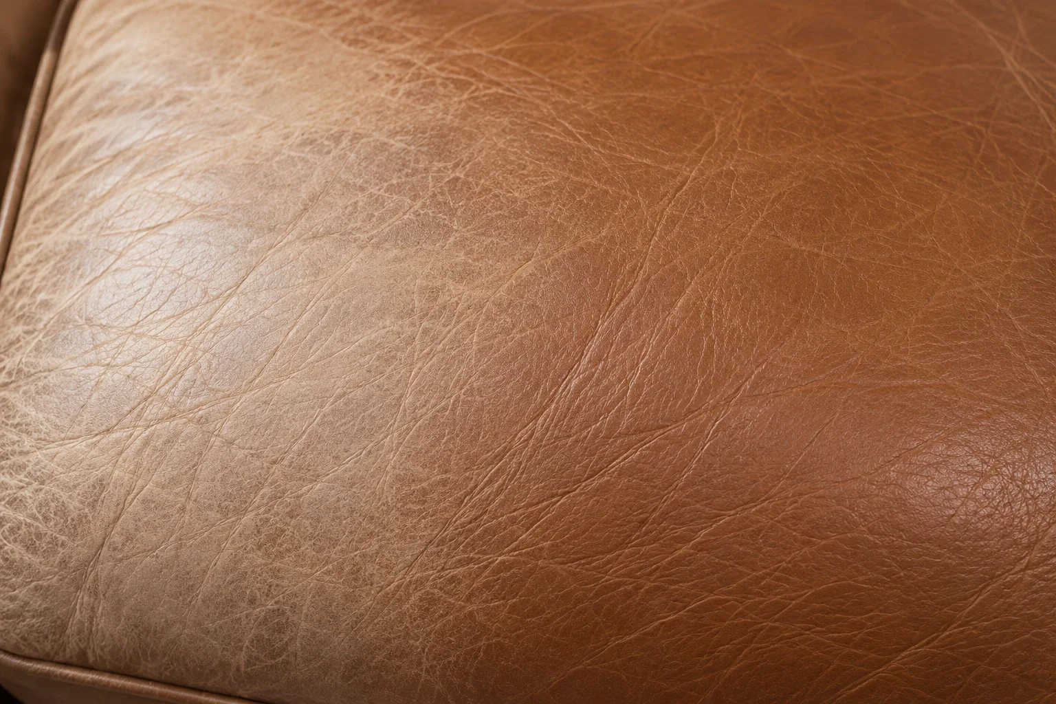 Heavily faded leather that has become significantly lighter and uneven