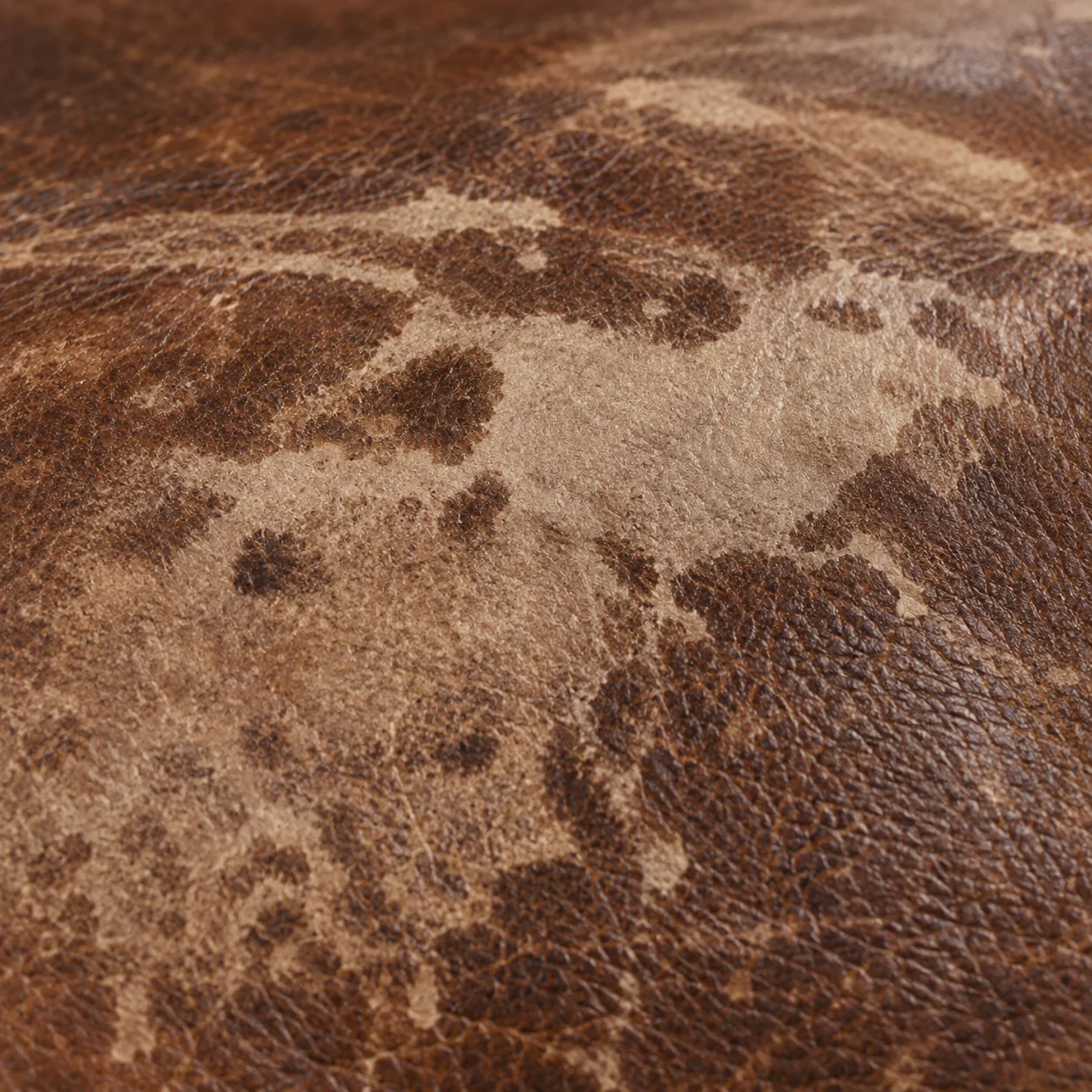 Finish rubbed away to pale raw hide