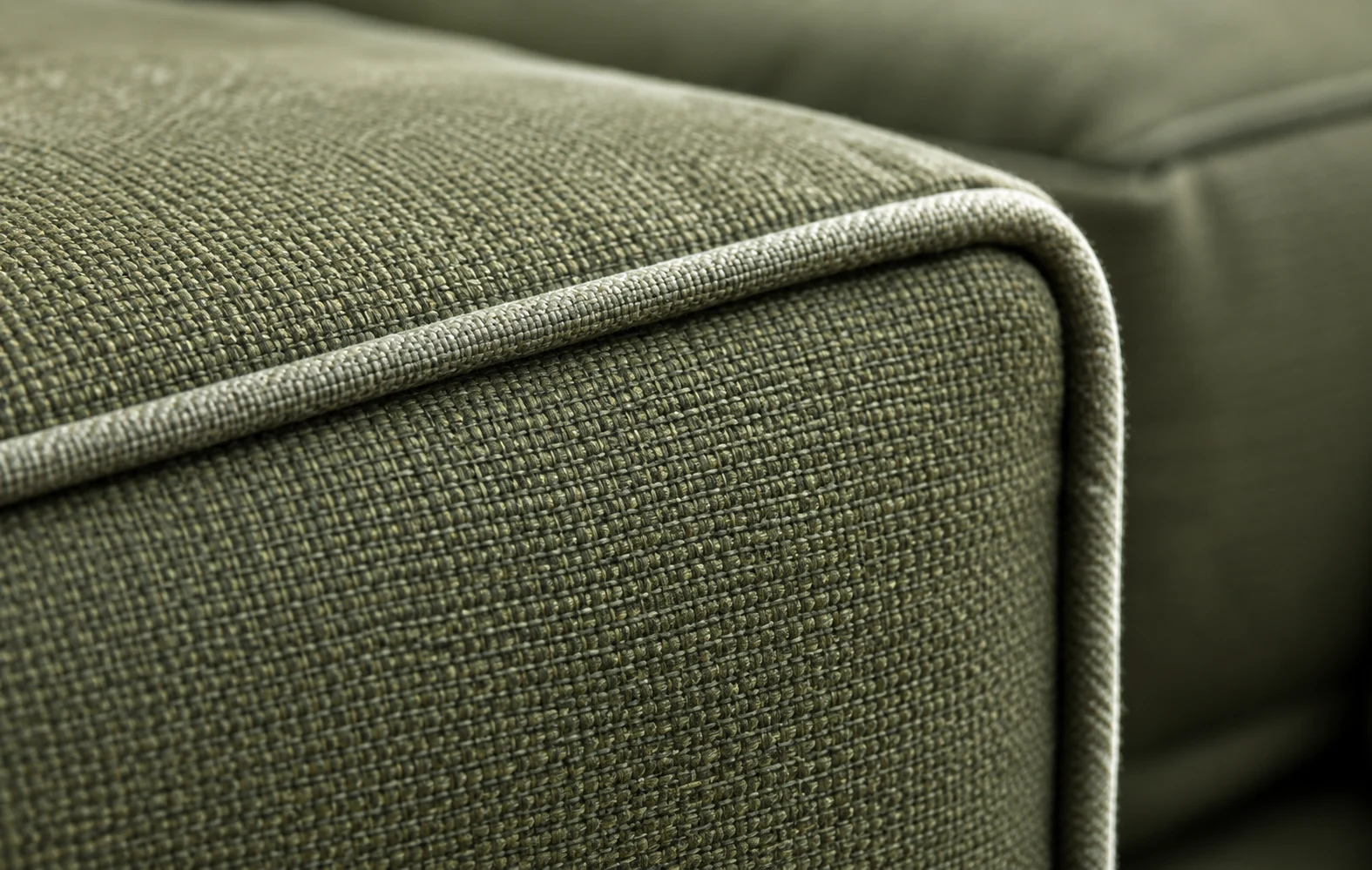 Welted corner detail on a green outdoor cushion