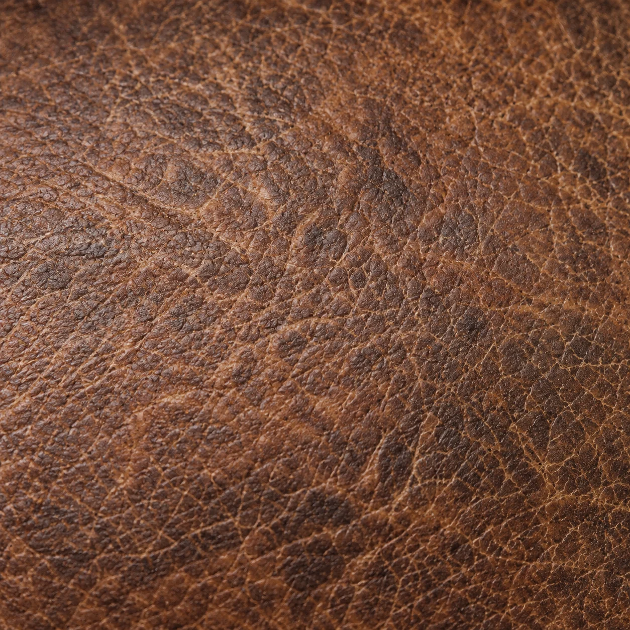 Close view of aged brown leather grain with no cracking
