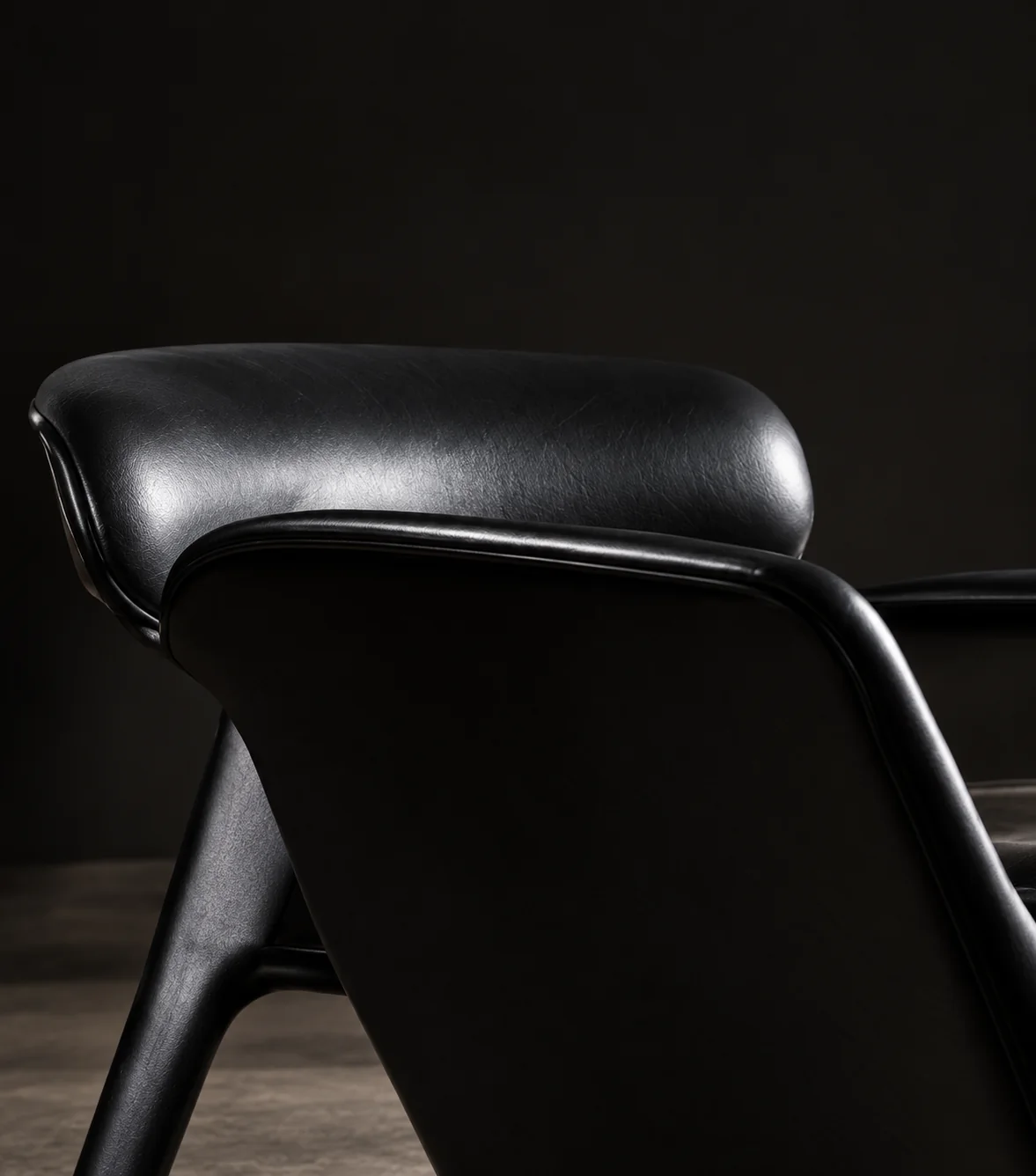 Black leather shell chair with a moulded seat