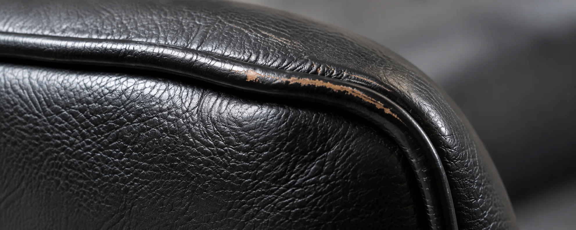 Scuffed leather on a Herman Miller armrest