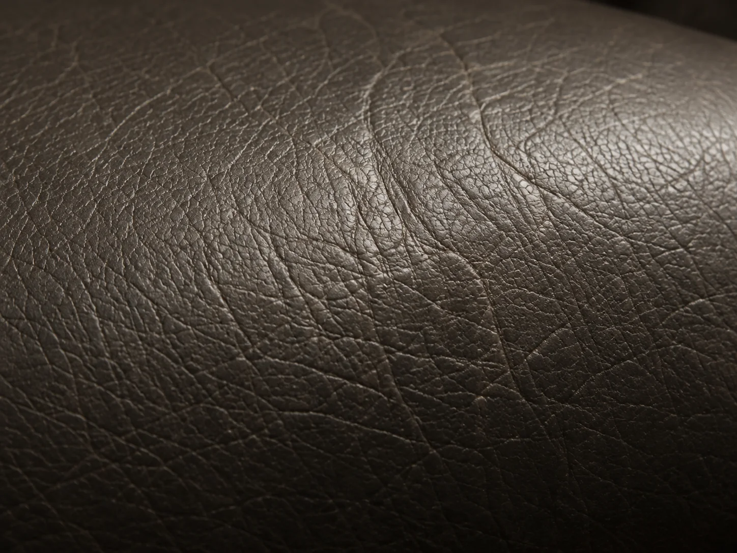 Dry brown leather on a Herman Miller armrest