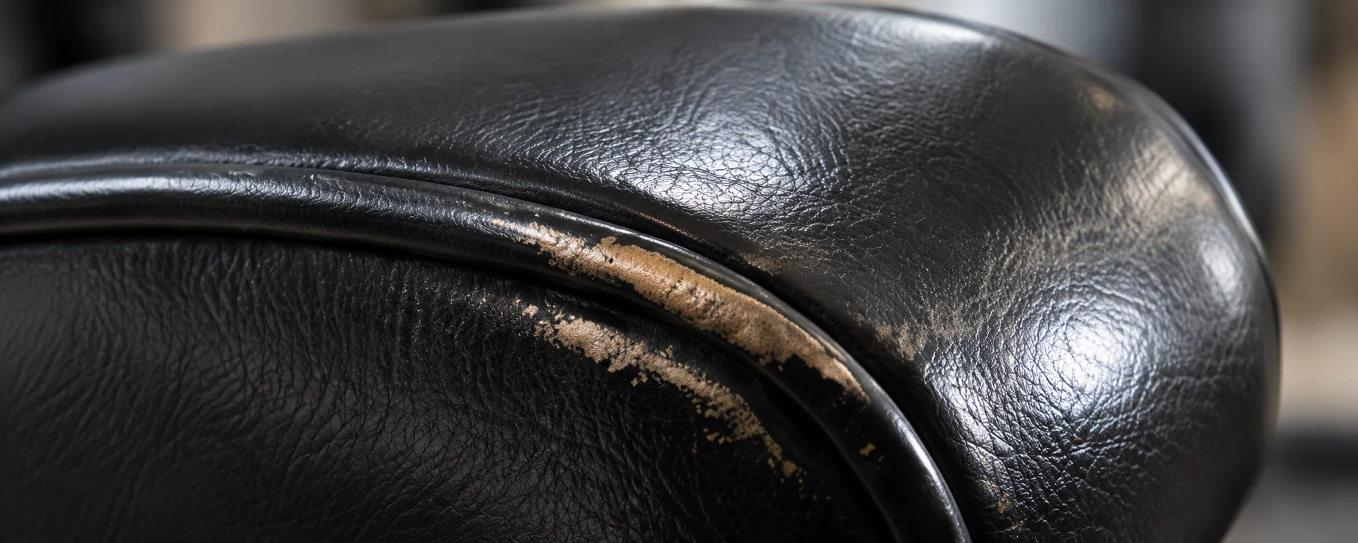 Worn piping along the edge of Herman Miller leather