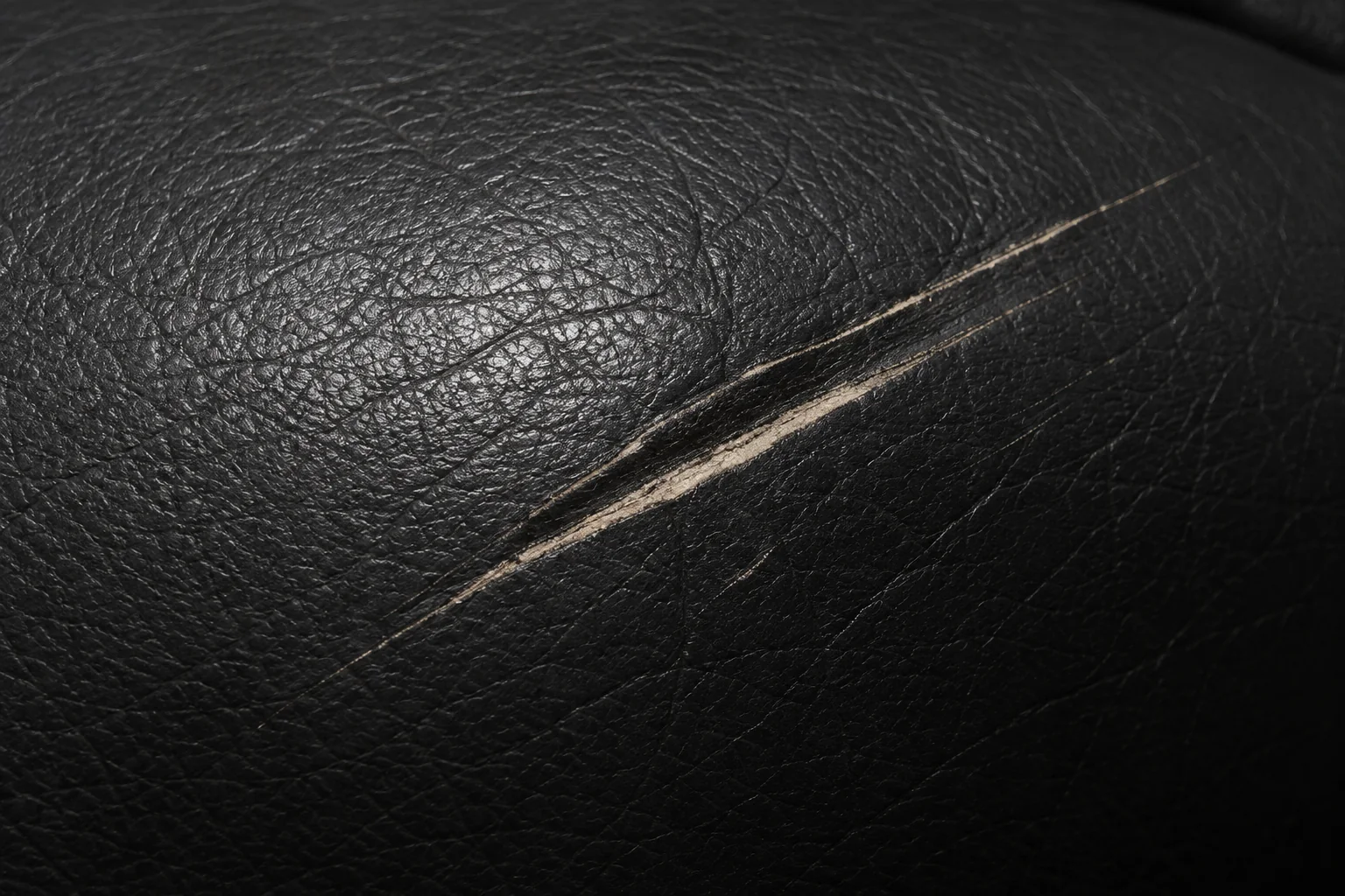 Scratches across a black leather Herman Miller cushion
