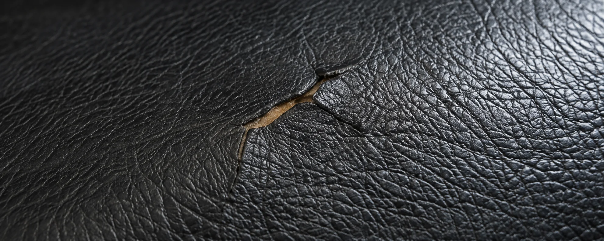 A small tear in a black leather Herman Miller cushion