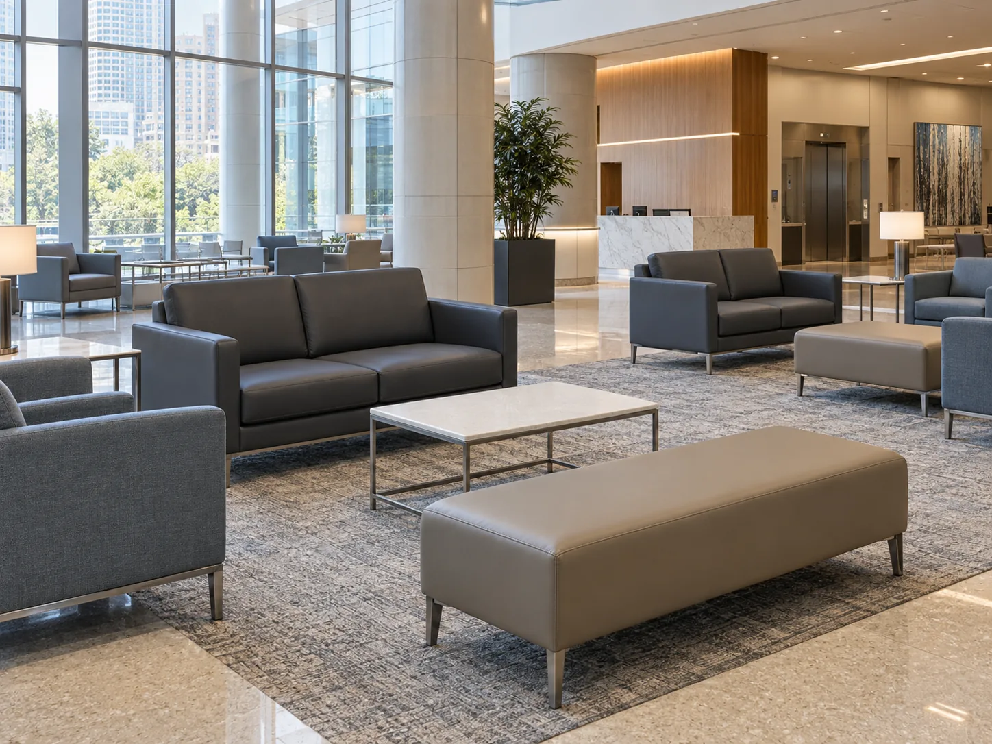 A hospital lobby with charcoal sofas, armchairs and upholstered benches