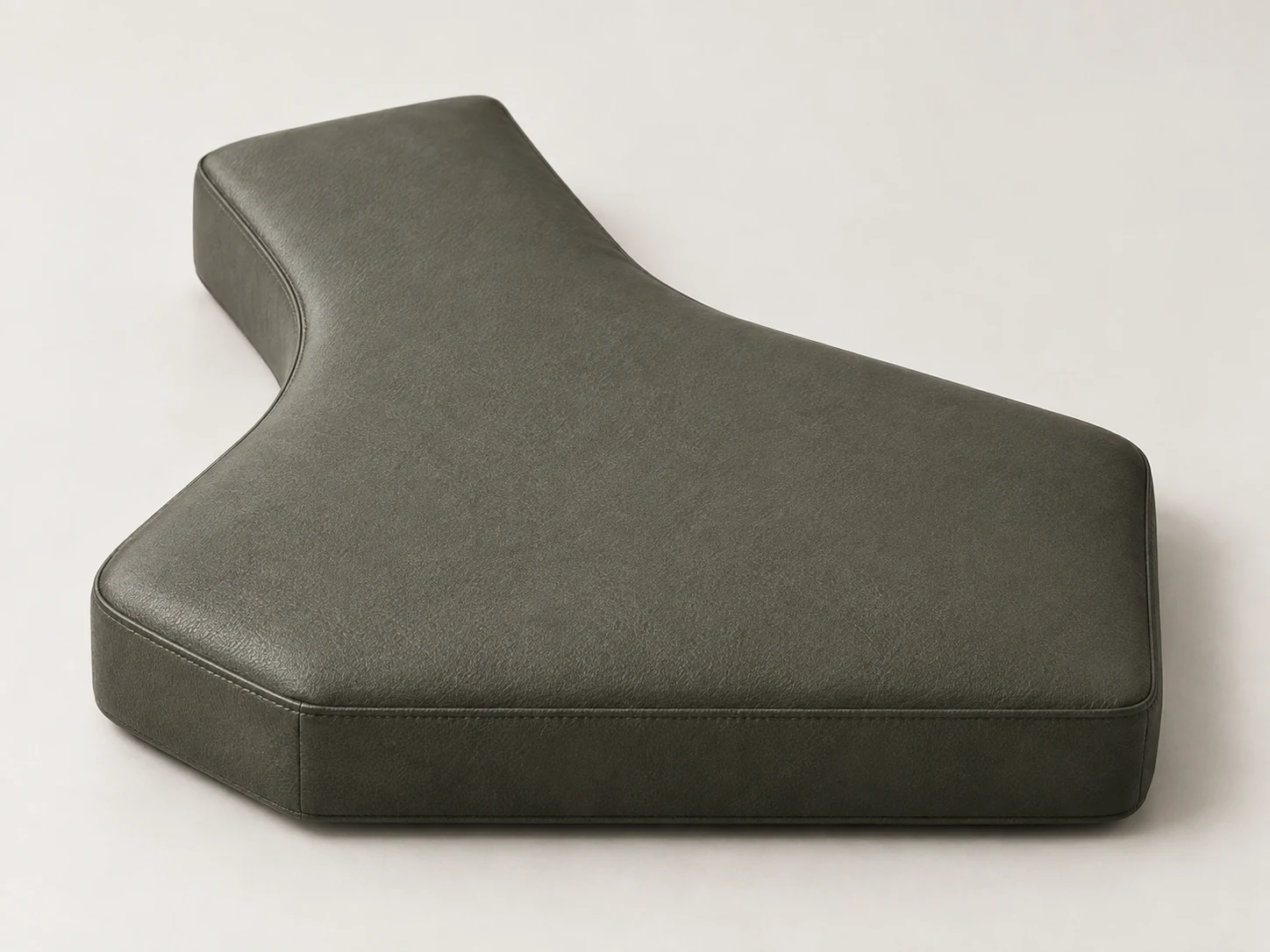 Irregular seat cushion shape cut around a built-in obstruction