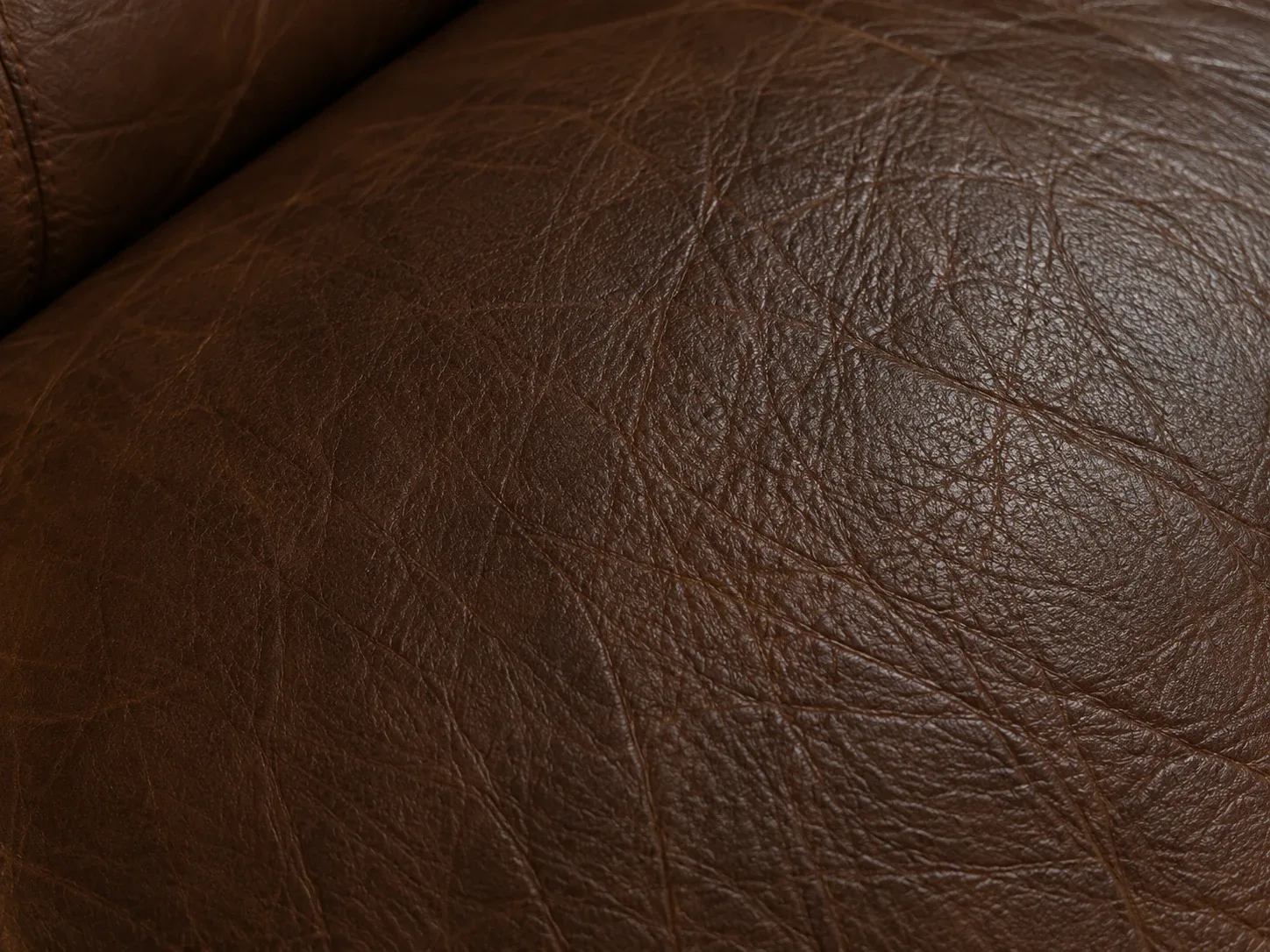 Leather seat panel darkened where hands and heads rest against it