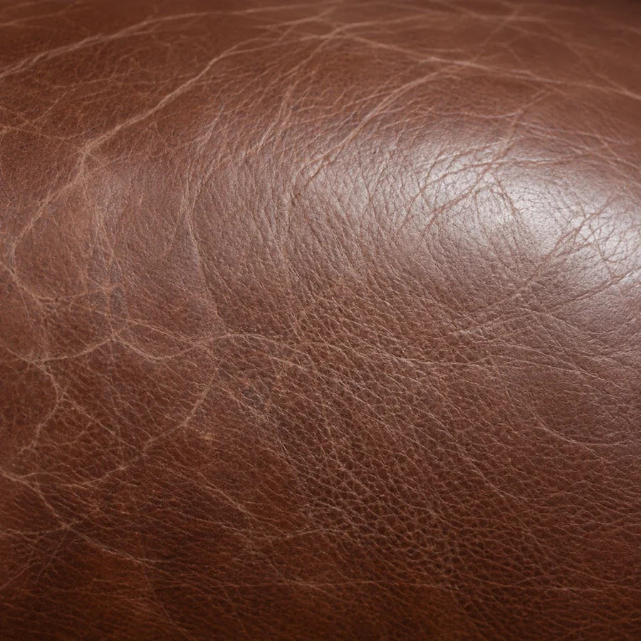 Close-up of brown leather worn pale where the pigment has gone