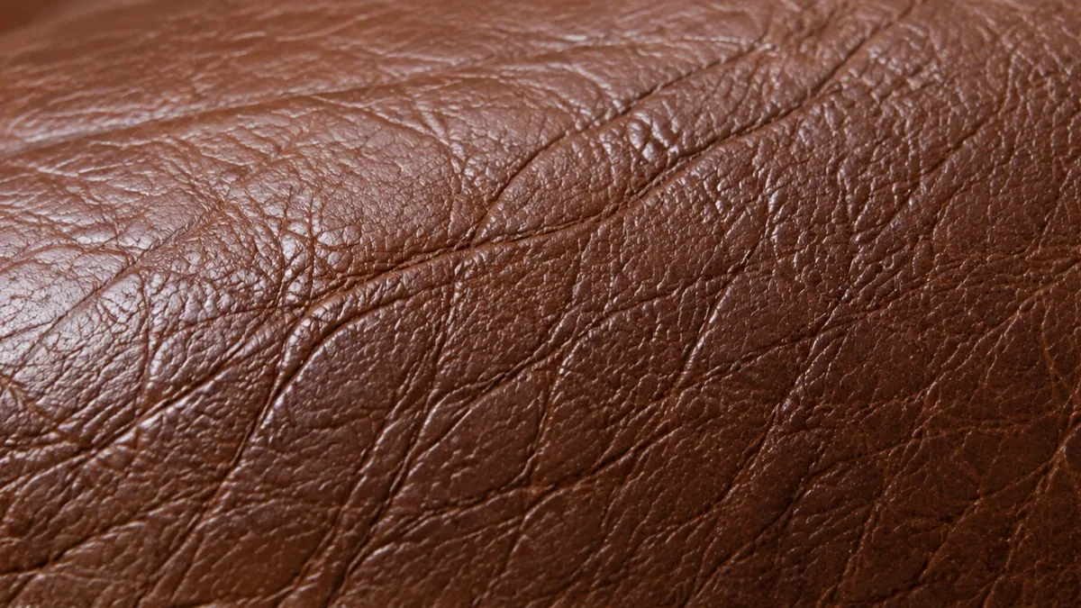 Close view of brown leather grain with fine creases and no crazing