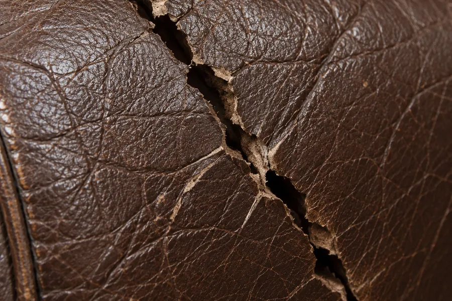 A deep crack opened right through the finish on a brown leather roll