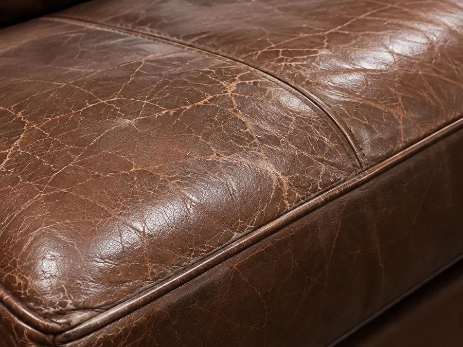 Crazing spread across the top of a brown leather seat cushion