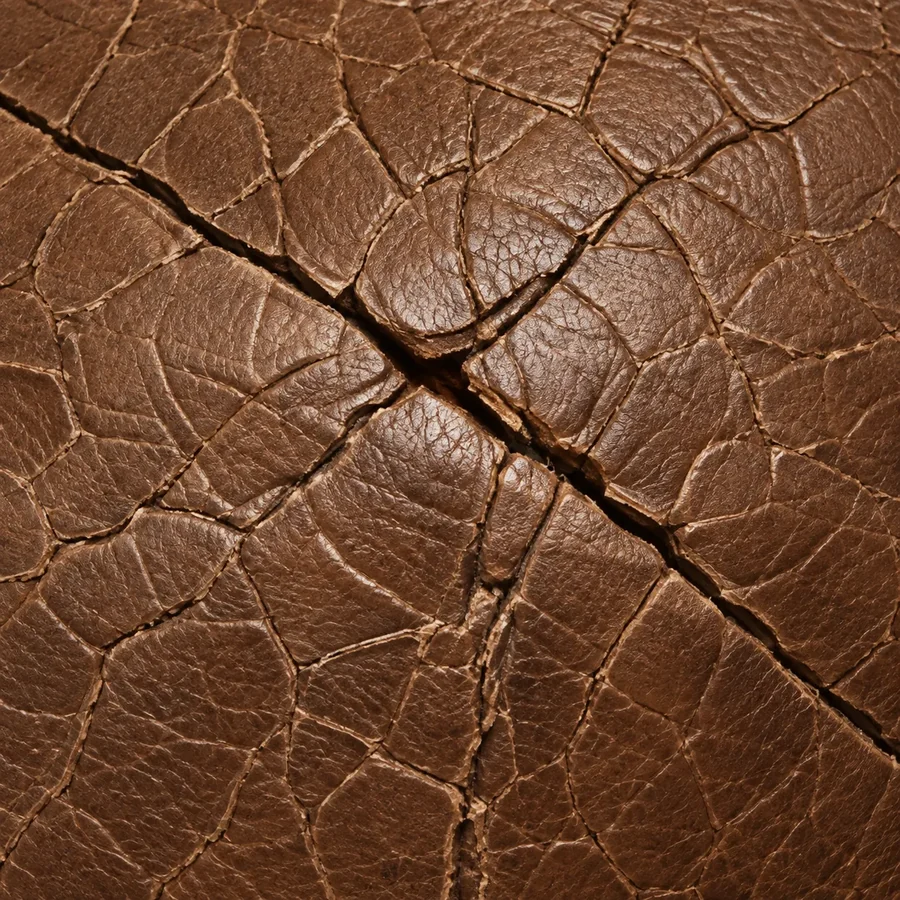 Close-up of dry cracking spreading across brown leather
