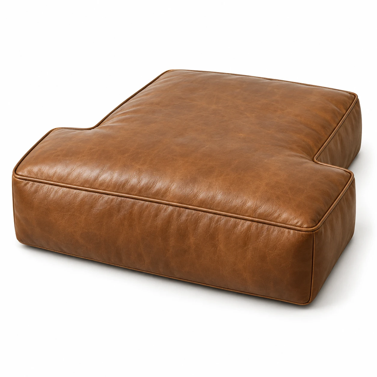 T-shaped tan leather seat cushion that wraps around a sofa arm