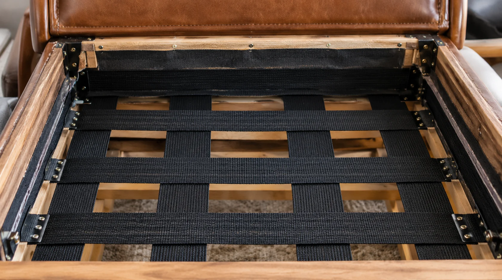 Elastic webbing across a sofa seat frame under the cushion